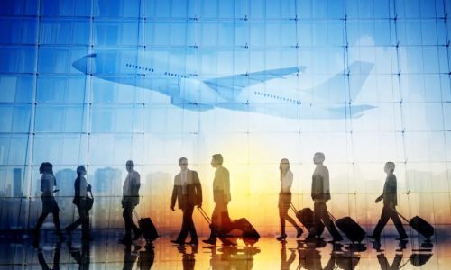 Group of Business Travellers Walking in an Airport