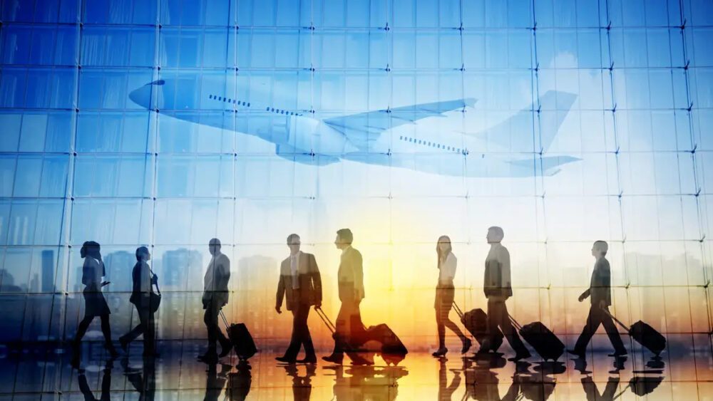 Group of Business Travellers Walking in an Airport